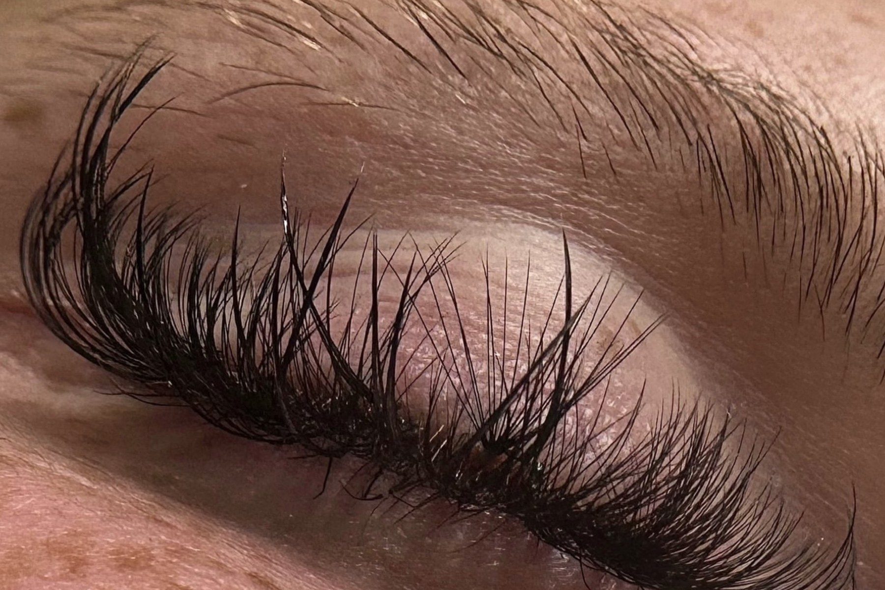 Close up of a client's eyes with freshly applied volume lash extensions
