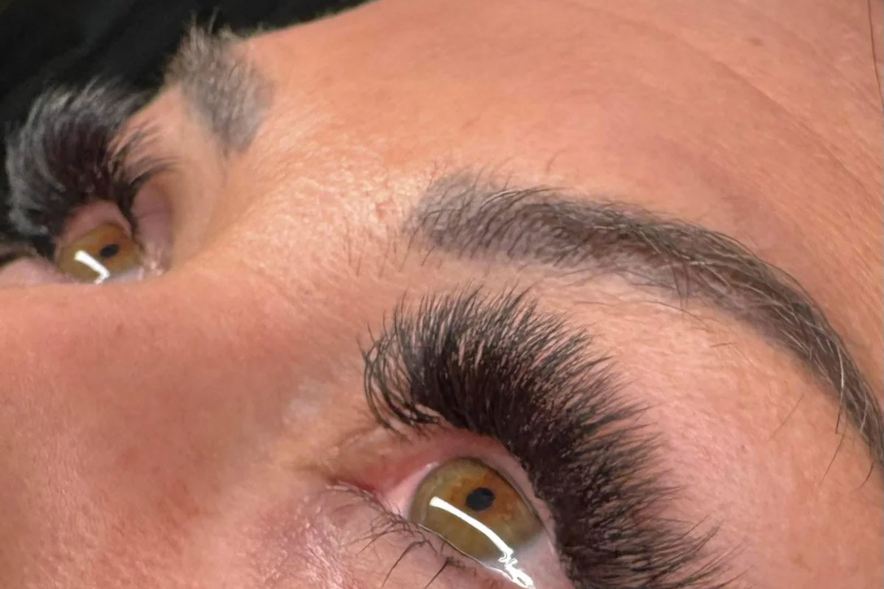 Client with lifted, curled lashes resting after a lash appointment