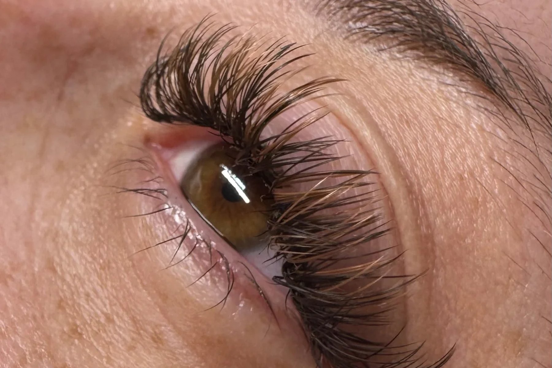 Fluttery lash extensions applied on a client resting with eyes closed
